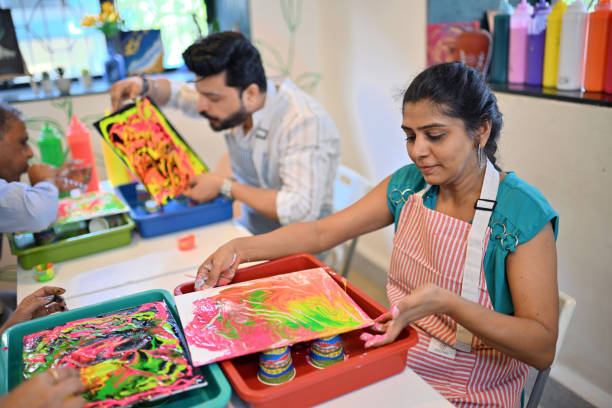 istock Creative fluid art session at an art workshop with participants engaged in colorful activities 2195065436