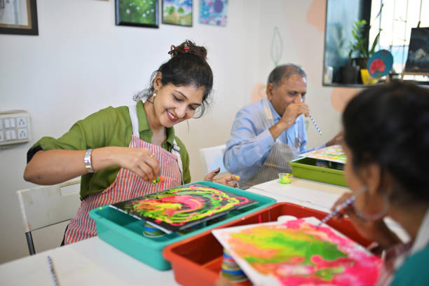 istock Creative fluid art session at an art workshop with participants engaged in colorful activities 2195065445