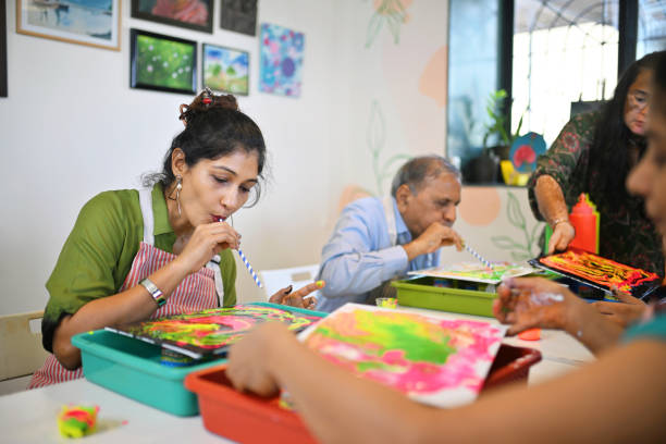 istock Creative fluid art session at an art studio with mixed age participants engaged in colorful activities 2195065453