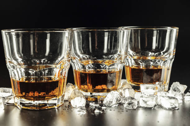 istock Whiskey and ice on rustic wood background 2195069910