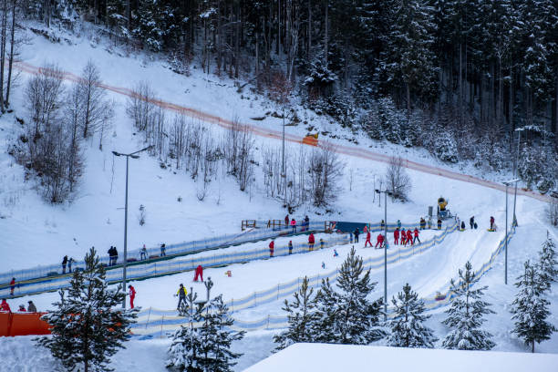 Therese Johaug (NOR) leads Heidi Weng (NOR) on a downhill during  the Women's World Cup Cross Country Skiathlon Ski Race on March 9, 2016 at the Canmore Nordic Centre Provincial Park in Alberta, Canada. Heidi Weng would go on to win, Therese Johaug finished second and Astrid Uhrenholdt Jacobsen (NOR) would go on to finish third. (John Gibson Photo/Gibson Pictures)