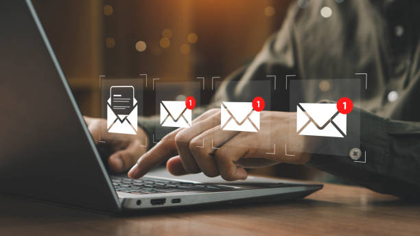 istock New email notification interaction concept. A person interacting with a floating digital interface showing a new email notification symbol, a concept for online communication. E-mail marketing 2195070733