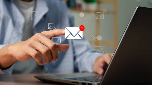 istock New email notification interaction concept. A person interacting with a floating digital interface showing a new email notification symbol, a concept for online communication. E-mail marketing 2195070737