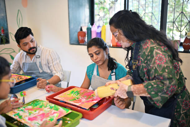 istock Passionate woman artisan teaching participants creative fluid art at a workshop 2195071249