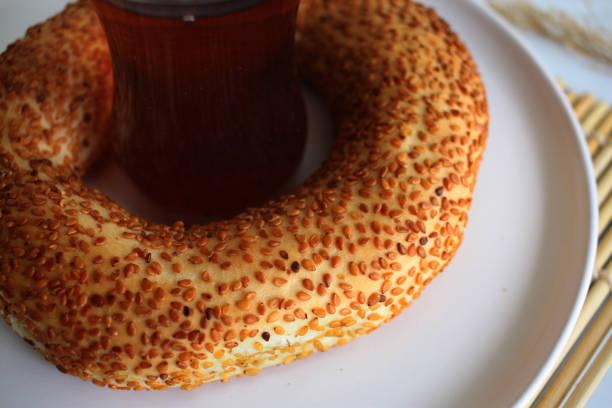 Bagel with a cup of black tea. Turkish tea, simit on the plate. Menu concept. Close up. High quality photo