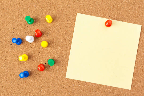 istock note paper pined on brown cork board background 2195073223
