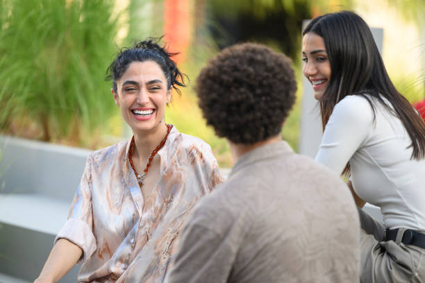 Three young people enjoying a laugh together outdoors