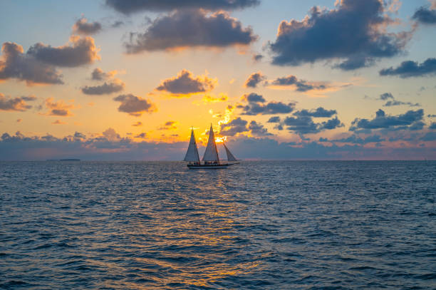 istock Sailboat silhouette with a setting sun from Florida Keys 2195076040