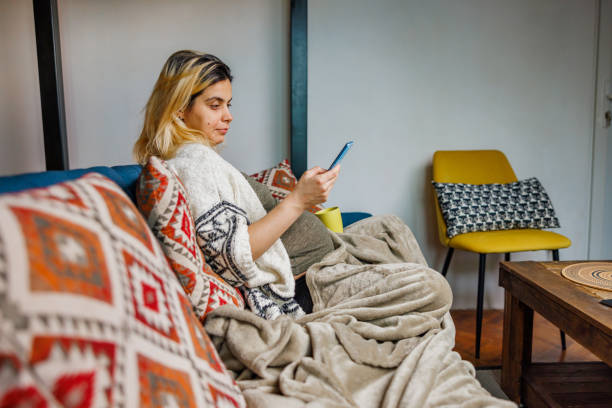 istock How a Smartphone Helps a Woman Rest at Home 2195076413