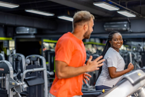 istock Two People Enjoying a Collaborative Workout in a Modern Gym Environment 2195078587