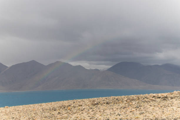 Rainbow over Pangong Tso Lake with a Himalayan mountain view situated on the border with India and China, Leh, Ladakh, India.