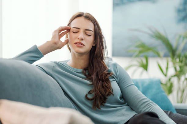 istock Young woman at home having a headache 2195082226