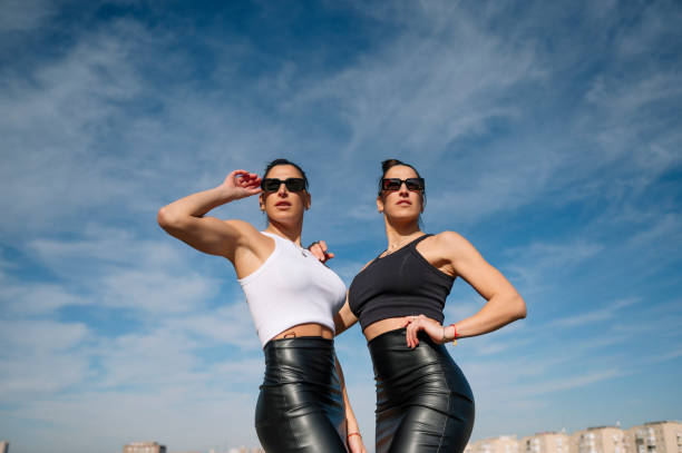 istock Powerful women posing confidently against vibrant sky, embodying empowerment, unity, and modern fashion sense 2195085728