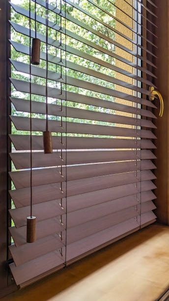 istock Wood blinds close-up on wooden window. 2195085947