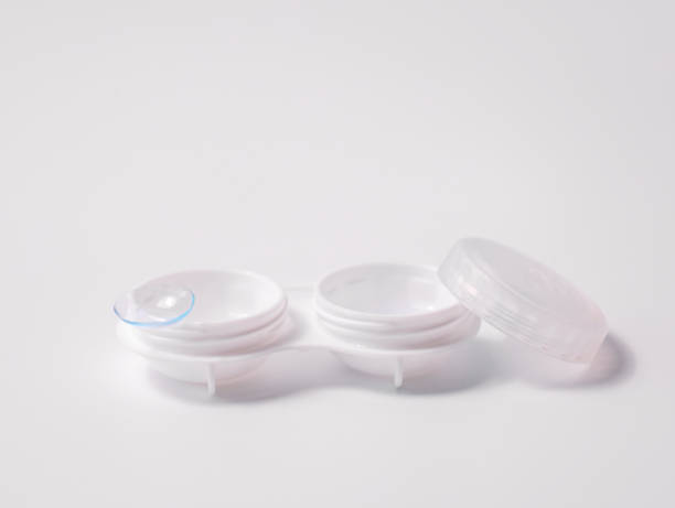 istock White contact lens case with a transparent lens on one side, placed on a clean white background. Minimalist design representing vision correction, hygiene, and eye care essentials 2195086084
