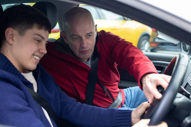 istock Father Helping Son With His New Car 2195088166