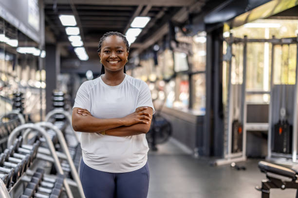 istock Confident Woman Smiling in a Gym with Modern Equipment 2195089082