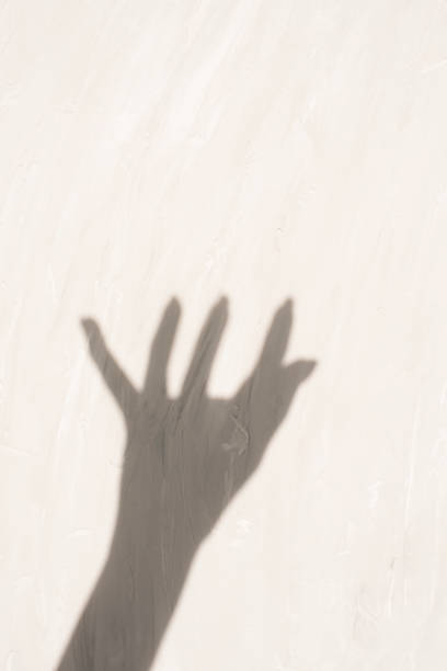 istock Hand shadow on a light background with texture. Effective minimalist shot with soft shadows and natural lighting. copy space 2195089777