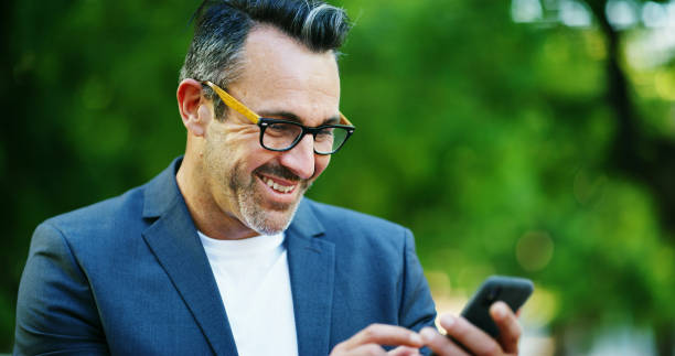 istock Park, happy and business man with phone for communication, typing email and b2b networking. Professional, corporate and worker on smartphone for connection, online website and social media outdoors 2195090192