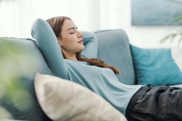 istock Relaxed young woman napping on the couch 2195091276