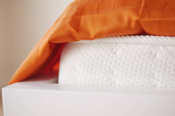 Single bed with a blanket and unmade bedclothes in bedroom of home or hotel room in early morning