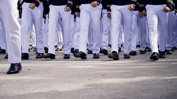 istock A group of Army soldiers in uniform marching in unison during a training drill or parade, showcasing discipline and precision. 2195093025