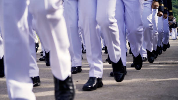 istock A group of Army soldiers in uniform marching in unison during a training drill or parade, showcasing discipline and precision. 2195093037