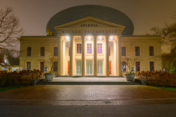 Fundatie museum in Zwolle at during a winter evening. The Fundatie is known for its striking architecture and diverse collection of art, ranging from classic to contemporary pieces. The museum building itself is a work of art. It is housed in the former Palace of Justice at the Blijmarkt, a neoclassical building that dates back to the 19th century. The most distinctive feature of the museum is the modern addition called \