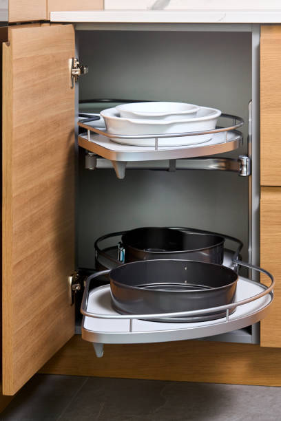 istock Kitchen access mechanism Magic corner for Blind Corner Cabinets pushed inside cabinet. Solution for a kitchen corner storage in cupboard. Corner unit with pull out shelves for cookware. 2195097652