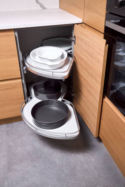 istock Kitchen access mechanism Magic corner for Blind Corner Cabinets pushed inside right cabinet. Solution for a kitchen corner storage in cupboard. Corner unit with pull out shelves for cookware. 2195097746