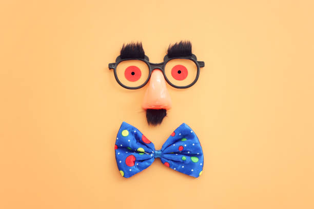 carnival, party and Purim celebration concept (jewish carnival holiday) over yellow background