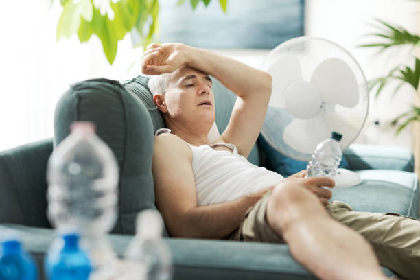 istock Man resting at home during a summer heatwave 2195099736