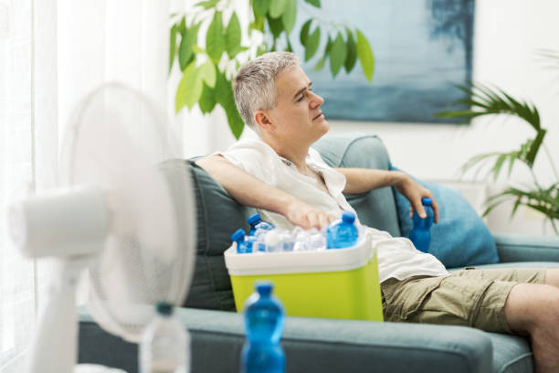 istock Exhausted man suffering from the heat at home 2195099754