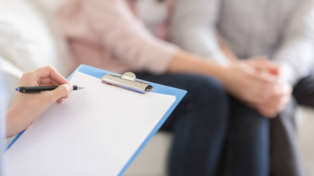istock Psychotherapist writing in blank notepad at therapy session 2195099864