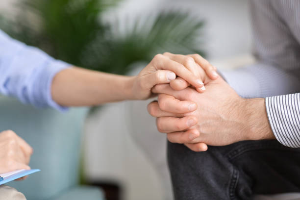 istock Woman holding man's hand in support gesture 2195099880