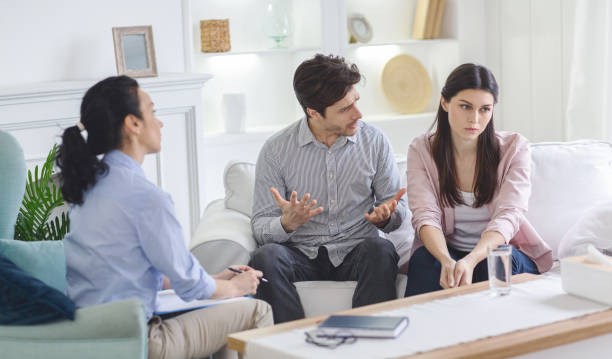 istock Couple Discusses Relationship Issues With Therapist in Modern Living Room Setting 2195099921