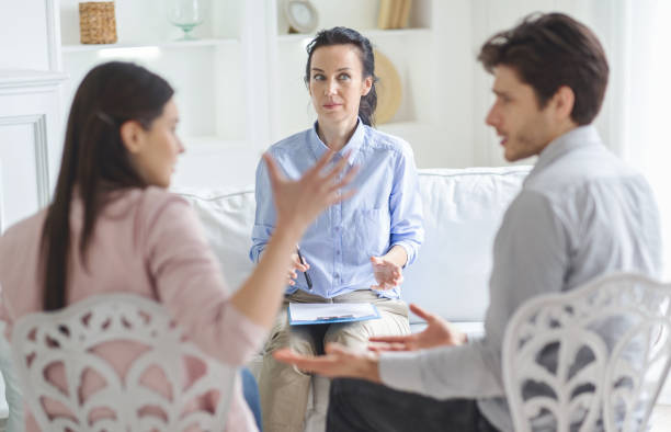 Couples Therapy Session With a Counselor Guiding a Conversation in a Bright Room