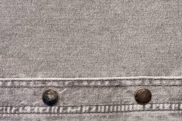 Macro background photography of denim fabric, grey jeans cloth, buttons and seam, fashion, design, textured frame, blank photo