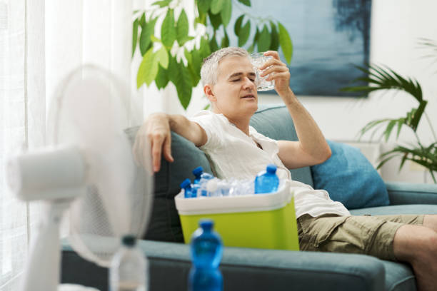 istock Exhausted man suffering from the heat at home 2195099990