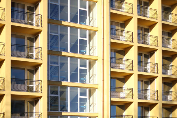 istock Yellow building with metal-railed balconies. 2195102336