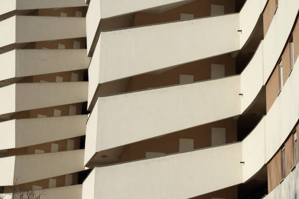 The photo highlights a modern geometric building detail with clean lines and sharp angles. The unique architectural design showcases a minimalist approach, emphasizing form and structure.