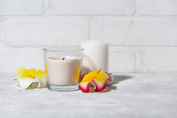 istock white scented candles and flowers on a white background 2195103269