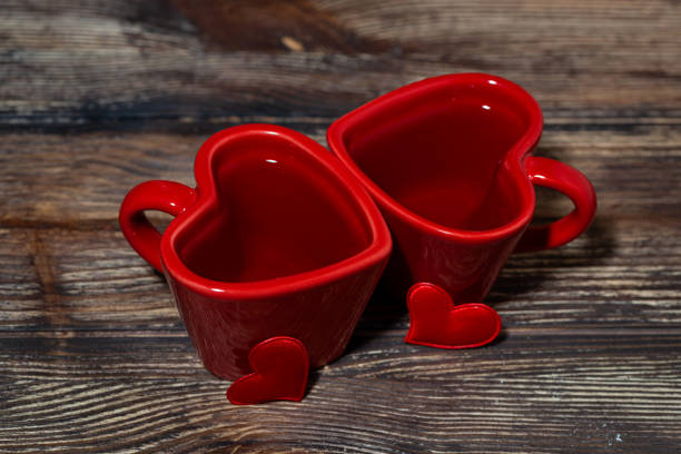 two red cups of tea on wooden background, top view horizontal