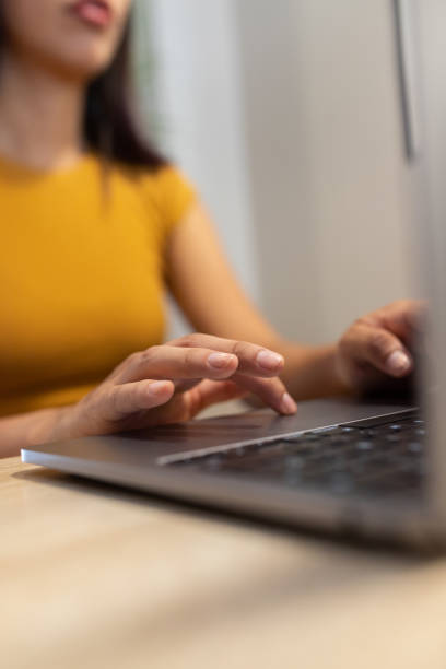 istock Anonymous woman typing on laptop during workday 2195104096