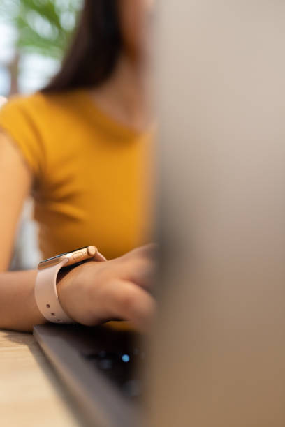 istock Anonymous woman typing on laptop during workday 2195104173