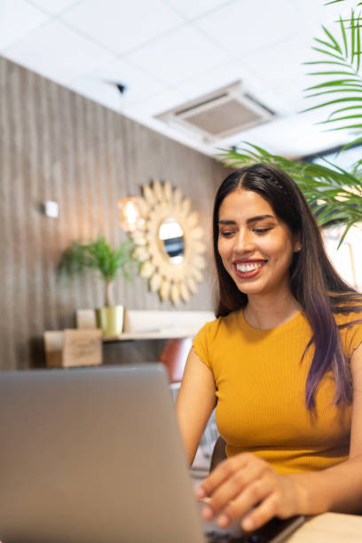 istock Cheerful woman typing on laptop during workday 2195104212