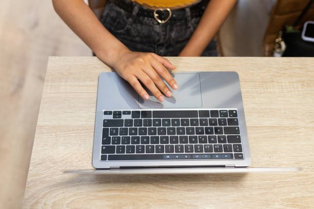 istock Anonymous woman typing on laptop during workday 2195104227