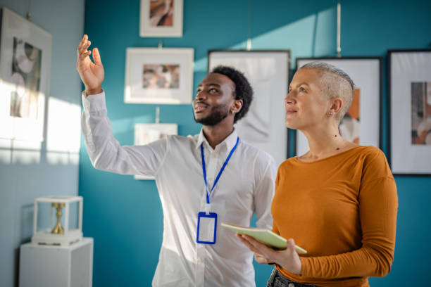 istock Engaging discussion between a gallery guide and a visitor at an art exhibition in a contemporary setting 2195104335