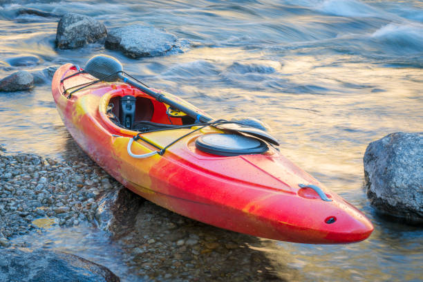 istock whitewater kayak on a river shore with a rapid in background 2195105011