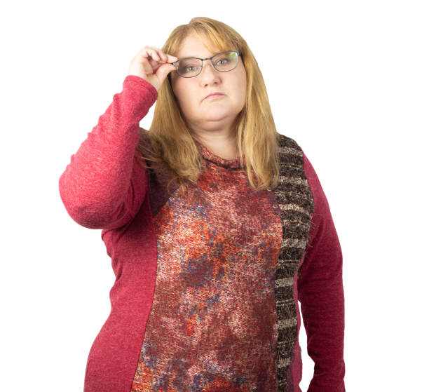 istock Thoughtful Woman Holding Glasses with a Focused Look 2195105775